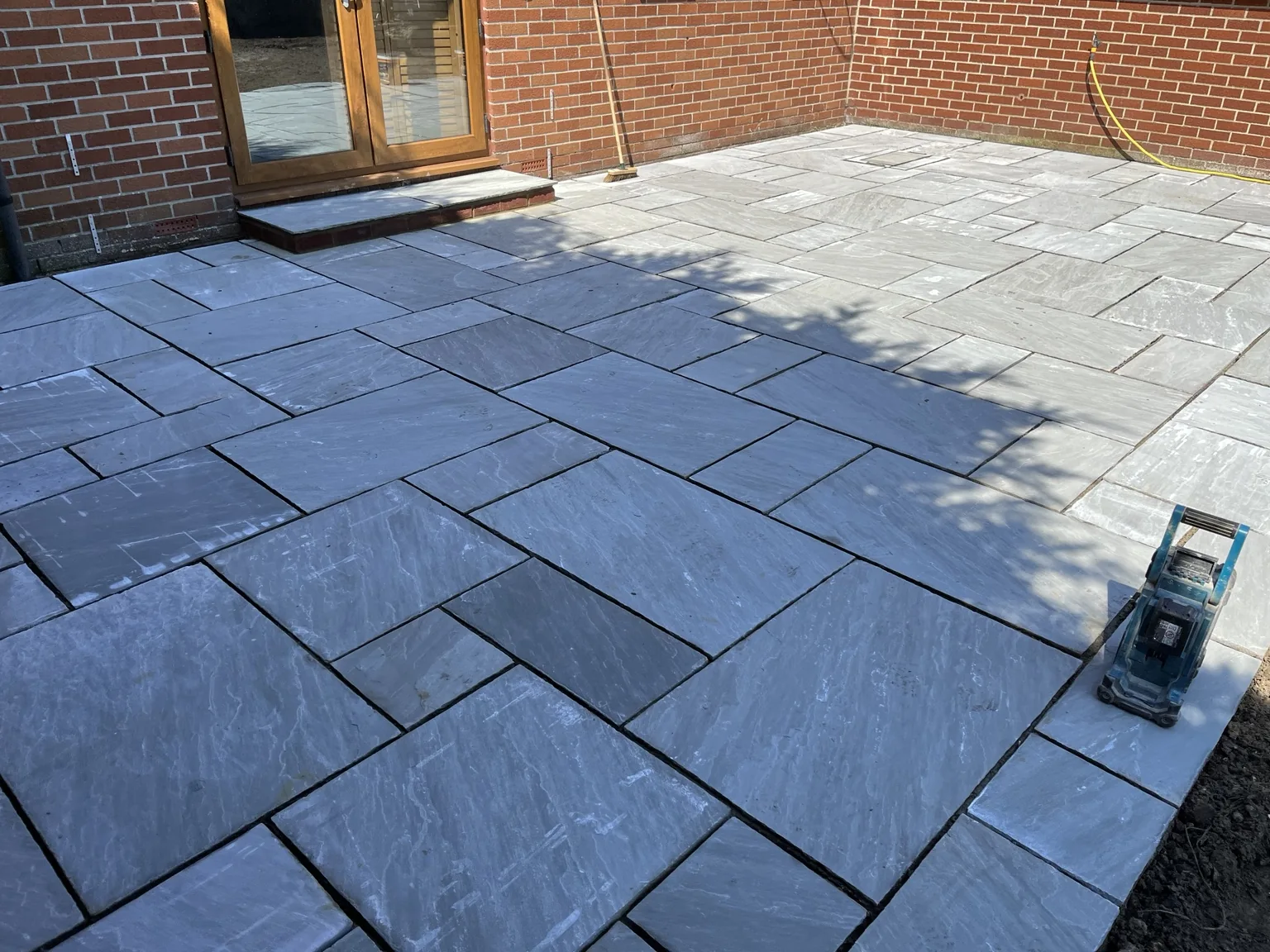 Natural stone patio and paving completed by Four Corners Landscaping
